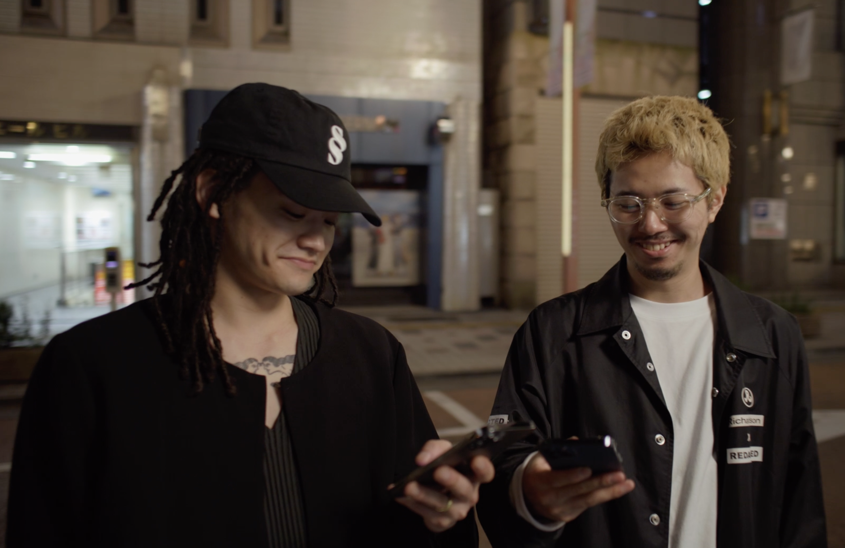 two users on the streets, looking at phones